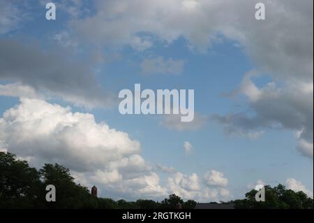 Fair weather cumulus clouds hovering over Lincoln on a summer evening. Lincoln, Nebraska, USA. Stock Photo