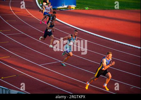 B. BYSTRICA, SLOVAKIA, JULY 20, 2023: Men Participating in the 200m Sprint Race at Track and Field Championship for Worlds in Budapest and Summer olym Stock Photo
