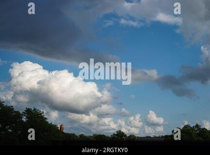 Fair weather cumulus clouds hovering over Lincoln on a summer evening. Lincoln, Nebraska, USA. Stock Photo
