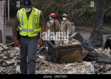 Lahaina, United States. 10th Aug, 2023. Hawaii Army National Guard SAR soldiers and local police search the remains of burnt out homes in the aftermath of wildfires that destroyed most of the historic town, August 10, 2023 in Lahaina, Maui, Hawaii. Wildfires fanned by high winds have killed at least 55 people and destroyed thousands of homes on the island. Credit: MSgt. Andrew Jackson/US Air Force Photo/Alamy Live News Stock Photo