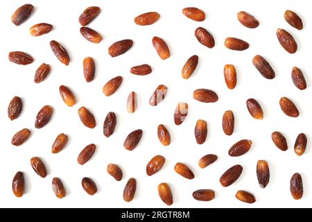Pattern of dried dates isolated on a white background. Traditional Arabic food. Dried fruits. Top view, flat lay. Stock Photo