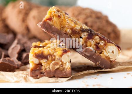 nuts, air rice, chocolate and other ingredients in a chocolate bar, a close up of food from different ingredients, a high calorie energy bar Stock Photo
