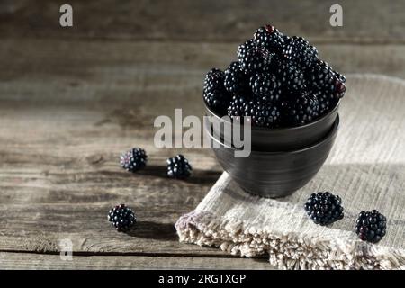 Fresh ripe blackberries on rustic wooden table. Space for text Stock Photo