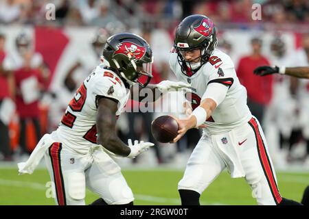 Tampa Bay Buccaneers quarterback Kyle Trask right hands off to