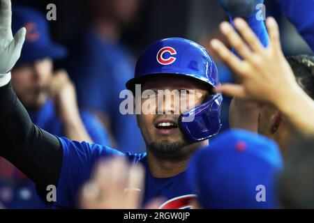 Chicago Cubs' Seiya Suzuki, left, is congratulated by first base coach Mike  Napoli after hitting a single against the San Francisco Giants during the  eighth inning of a baseball game in San