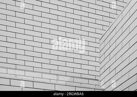 Black and white tone, Abstract architectural detail of modern white clean ceramic tiles with running bonds pattern facade. Stock Photo
