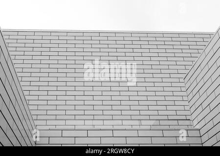 Black and white tone, Abstract architectural detail of modern white clean ceramic tiles with running bonds pattern facade. Stock Photo