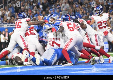 Detroit Lions quarterback Adrian Martinez (18) keeps the ball