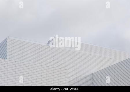 Black and white tone, Abstract architectural detail of modern white clean ceramic tiles with running bonds pattern facade. Stock Photo