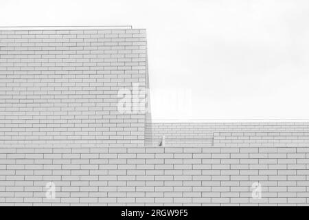 Black and white tone, Abstract architectural detail of modern white clean ceramic tiles with running bonds pattern facade. Stock Photo