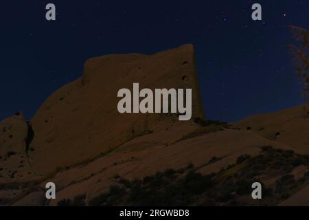 Experience the serenity of the night with this long-exposure photograph at the iconic Mormon Rocks in the Cajon Pass. Stock Photo