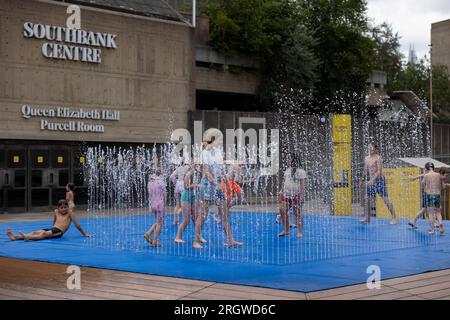 London, UK. 11th Aug, 2023. Kids have fun at the fountain area outside Southbank Centre amid the hot weather caused by the mini-heat wave after storm Antoni last week. Credit: SOPA Images Limited/Alamy Live News Stock Photo