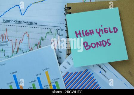Concept of High Yield Bonds write on sticky notes isolated on Wooden Table. Stock Photo