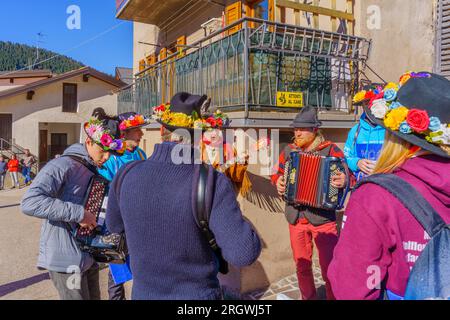 Valfloriana, Italy - February 26, 2022: Youth born in 2004 celebrate reaching legal drinking age (wine pass), in the Valfloriana 2022 carnival, Trenti Stock Photo