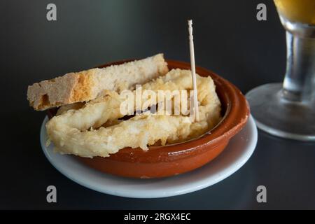 Close-up of a tapa of battered squid with a beer in a cafeteria. Island of Mallorca, Spain Stock Photo