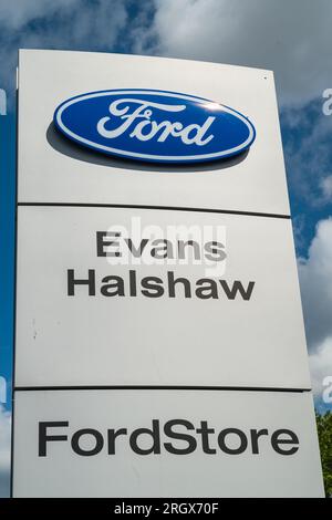 Wolverhampton, UK - August 11 2023:  A Ford advertising board outside of the Evans Halshaw Dealership with the Ford logo in Wolverhampton, UK Stock Photo