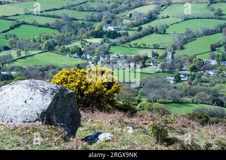 Looking down on the well known village of Widecombe in the Moor from Bonehill Rocks on Dartmoor on a sunny April day. Stock Photo