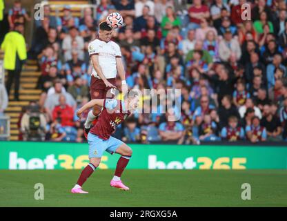 Manchester City's Phil Foden wins the header above Burnley's  Connor Roberts during the Burnley FC v Manchester City FC at Turf Moor Stadium Burnley 11 Aug 2023 Credit: Sharon Latham/Burnley FC/Alamy Live News Stock Photo