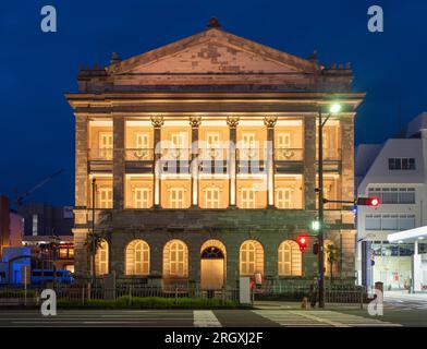 A night shot of the brightly lit up former Hong Kong and Shanghai Bank Nagasaki Branch Museum with its Romanesque pillars Stock Photo