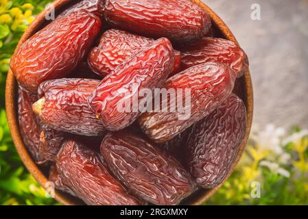 Close up for delicious organic Medjool dates. They have a sweet caramel taste and chewy texture. Dates are a popular treat in the Middle East. Stock Photo
