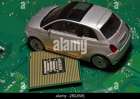 Toy car with CPU. The shortage of microchips and semiconductors creates a shortage of new cars. Conceptual image for semiconductor shortage disrupting Stock Photo