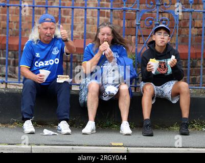 Goodison Park, Liverpool, UK. 12th Aug, 2023. Premier League Football, Everton versus Fulham; Everton supporters enjoying a pre match snack outside the stadium Credit: Action Plus Sports/Alamy Live News Stock Photo