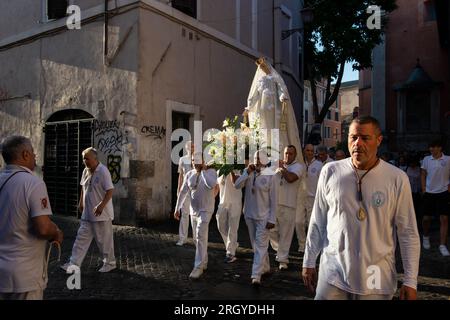 July 31, 2023 - Rome, Italy: Solemn celebration and procession in the streets of Trastevere in honor of Madonna del Carmine, Our Lady of Roman Citizens called 'de Noantri'. The bearers of the statue weighting 1,6 tons, are the Venerable Confraternity of the Blessed Sacrament and Maria del Carmine in Trastevere. The feast was officially instituted in 1927, but the origins date back to the 16th century. In 1535, after a flood, a statue of Mary carved out of cedar wood was found along the shores of the Tiber river. © Andrea Sabbadini Stock Photo