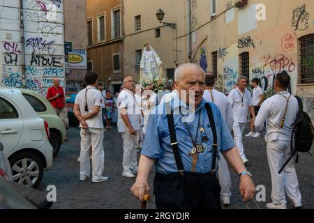 July 31, 2023 - Rome, Italy: Solemn celebration and procession in the streets of Trastevere in honor of Madonna del Carmine, Our Lady of Roman Citizens called 'de Noantri'. The bearers of the statue weighting 1,6 tons, are the Venerable Confraternity of the Blessed Sacrament and Maria del Carmine in Trastevere. The feast was officially instituted in 1927, but the origins date back to the 16th century. In 1535, after a flood, a statue of Mary carved out of cedar wood was found along the shores of the Tiber river. © Andrea Sabbadini Stock Photo