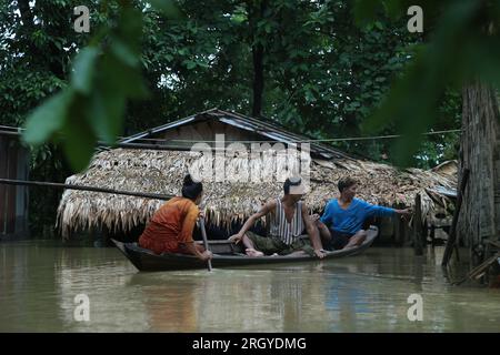 Bago, Myanmar. 12th Aug, 2023. People row a wooden boat on flood water in Bago, Myanmar, Aug. 12, 2023. Myanmar's Department of Disaster Management said on Friday that more than 45,000 people were currently in the flood shelters across the country due to floods triggered by surging river levels and intense rainfall in recent days.TO GO WITH 'Roundup: Over 45,000 displaced as floods, landslides hit Myanmar' Credit: Myo Kyaw Soe/Xinhua/Alamy Live News Stock Photo