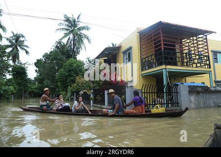 Bago, Myanmar. 12th Aug, 2023. People row a wooden boat on flood water in Bago, Myanmar, Aug. 12, 2023. Myanmar's Department of Disaster Management said on Friday that more than 45,000 people were currently in the flood shelters across the country due to floods triggered by surging river levels and intense rainfall in recent days.TO GO WITH 'Roundup: Over 45,000 displaced as floods, landslides hit Myanmar' Credit: Myo Kyaw Soe/Xinhua/Alamy Live News Stock Photo