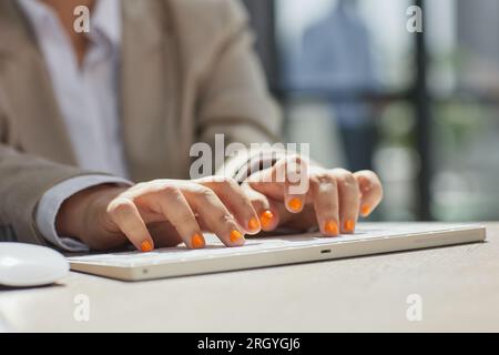 Close-up of businesswomans hand while working on her laptop Stock Photo