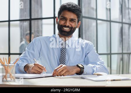 male investor beard looking at camera and smiling in modern office Stock Photo