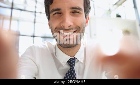 handsome businessman in formal wear smiling and looking at camera Stock Photo