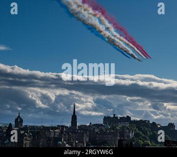 Edinburgh, Scotland, UK, 12th August 2023. Red Arrows flypast: the RAF display team flypast over Edinburgh Castle and the city centre for the early performance of the Military Tattoo. Credit: Sally Anderson/Alamy Live News Stock Photo