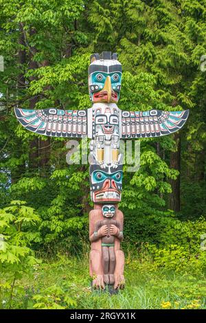 Carved house posts were used in traditional First Nations cedar houses to support the heavy roof beams.  This replica of an original post is on displa Stock Photo