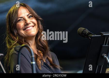 Cottbus, Germany. 12th Aug, 2023. Actress Bettina Zimmermann is on stage at the Elbenwald Festival for a live episode of the radio play 'Kohlrabenschwarz'. The Elbenwald Festival is a three-day gathering for people of all ages who enjoy movies, fantasy, games, concerts and any combination of the above. The organizers expect about 15,000 visitors. Credit: Frank Hammerschmidt/dpa/Alamy Live News Stock Photo