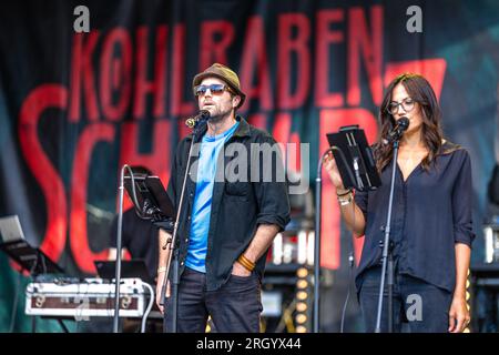 Cottbus, Germany. 12th Aug, 2023. Actor Peter Ketnath and actress Bettina Zimmermann are on stage at the Elbenwald Festival for a live episode of the radio play 'Kohlrabenschwarz'. The Elbenwald Festival is a three-day gathering for people of all ages who enjoy movies, fantasy, games, concerts and any combination of all. The organizers expect about 15,000 visitors. Credit: Frank Hammerschmidt/dpa/Alamy Live News Stock Photo