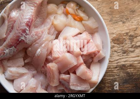 The raw ingredients for a fish stew or bouillabaisse. Clockwise from the top: Raw king scallops, smooth hound, anglerfish also known as monkfish, and Stock Photo