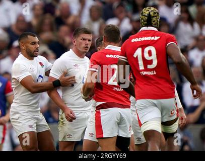 England's Owen Farrell is held back from Wales' Dan Biggar during the Summer Nations Series match at Twickenham Stadium, London. Picture date: Saturday August 12, 2023. Stock Photo