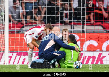 Amsterdam, Netherlands. 12th Aug, 2023. AMSTERDAM, NETHERLANDS - AUGUST 12: goalkeeper Geronimo Rulli of Ajax on the ground injured receives medical attention during the Dutch Eredivisie match between Ajax and Heracles Almelo at Johan Cruijff ArenA on August 12, 2023 in Amsterdam, Netherlands. (Photo by Peter Lous/Orange Pictures) Credit: Orange Pics BV/Alamy Live News Stock Photo
