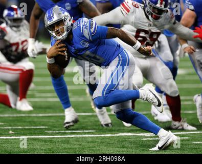 Detroit Lions quarterback Adrian Martinez (18) gets away from New