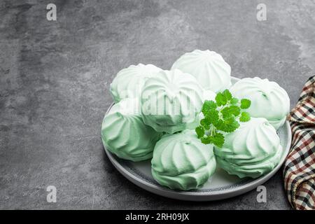 Mint  marshmallows on ceramic plate on gray background Stock Photo