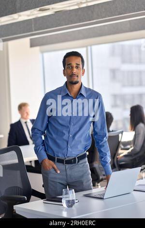 Confident African American young business man at workplace, vertical portrait. Stock Photo