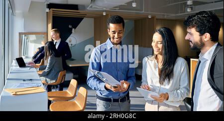 Young happy diverse professional team business people standing in office. Stock Photo