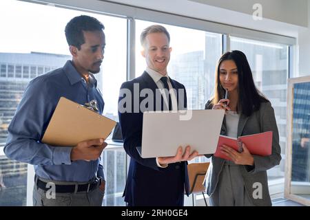 Diverse work team people looking at laptop discussing digital strategy. Stock Photo