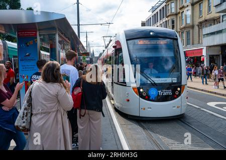 Public wait to board tram on Princes Street in Edinburgh, Scotland, Uk Stock Photo
