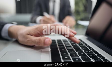 hand man using laptop contact business search information on desk at office. Stock Photo