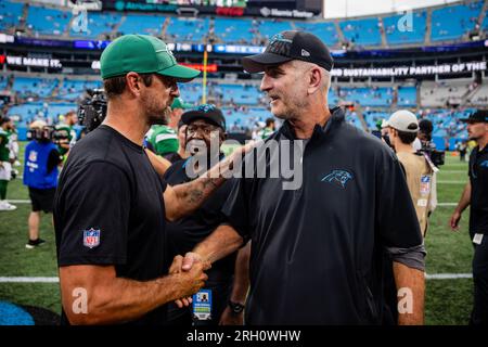 Charlotte, North Carolina, USA. August 12, 2023: New York Jets quarterback Aaron Rodgers (8) shakes hands with Carolina Panthers Head Coach Frank Reich after the NFL matchup in Charlotte, NC. (Scott Kinser/Cal Sport Media) Credit: Cal Sport Media/Alamy Live News Stock Photo