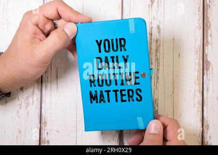 Handwriting text writing Your Daily Routine Matters on notebook. Stock Photo