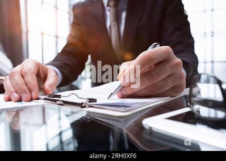 man hands with pen writing on notebook in the office.learning, education and work Stock Photo